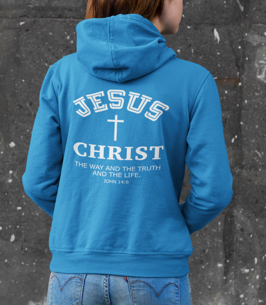 Person wearing a blue hoodie with 'Jesus Christ' text against a textured wall.