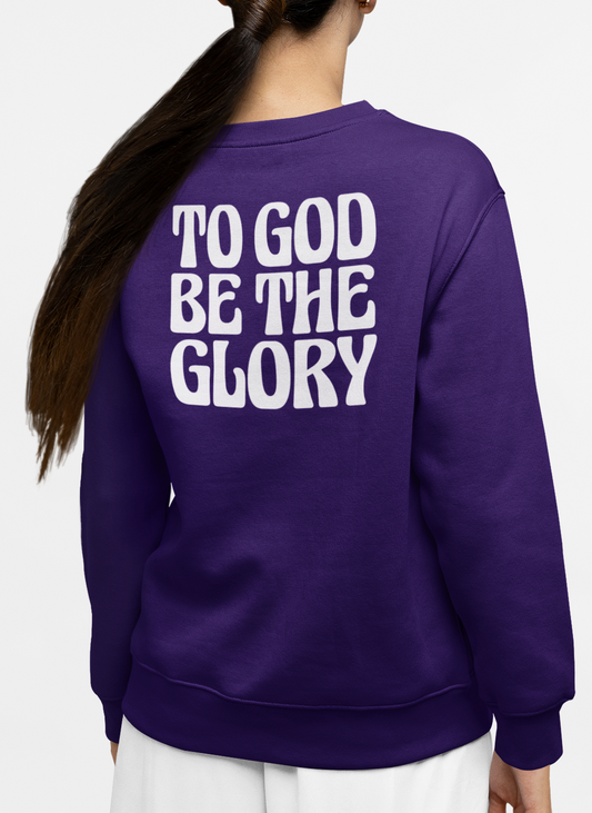 Woman wearing a purple sweatshirt with 'TO GOD BE THE GLORY' in white text