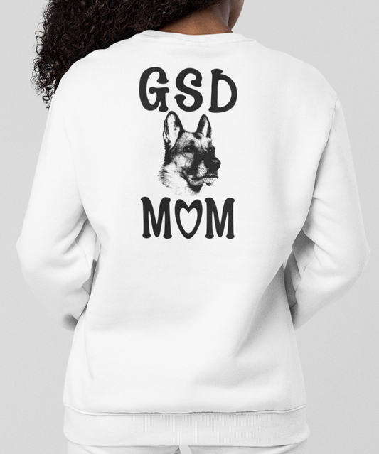 Woman wearing a white sweatshirt with 'GSD MOM' text and German shepherd graphic on the back