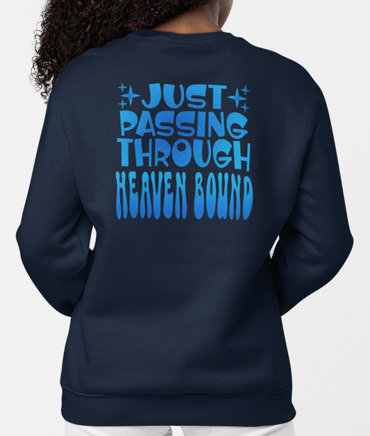 Woman wearing a navy blue sweatshirt with blue gradient text, 'Just Passing Through Heaven Bound' on the back