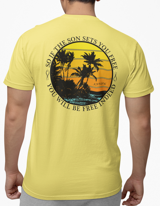 Man wearing a cornsilk t-shirt with a palm tree design on a distressed sunset background on the back