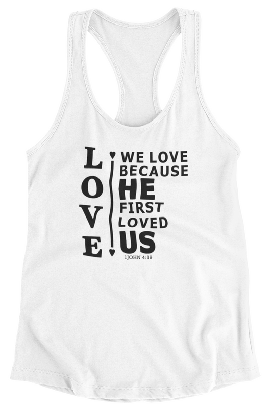 White women's racerback tank top with scripture verse 1 John 4:19