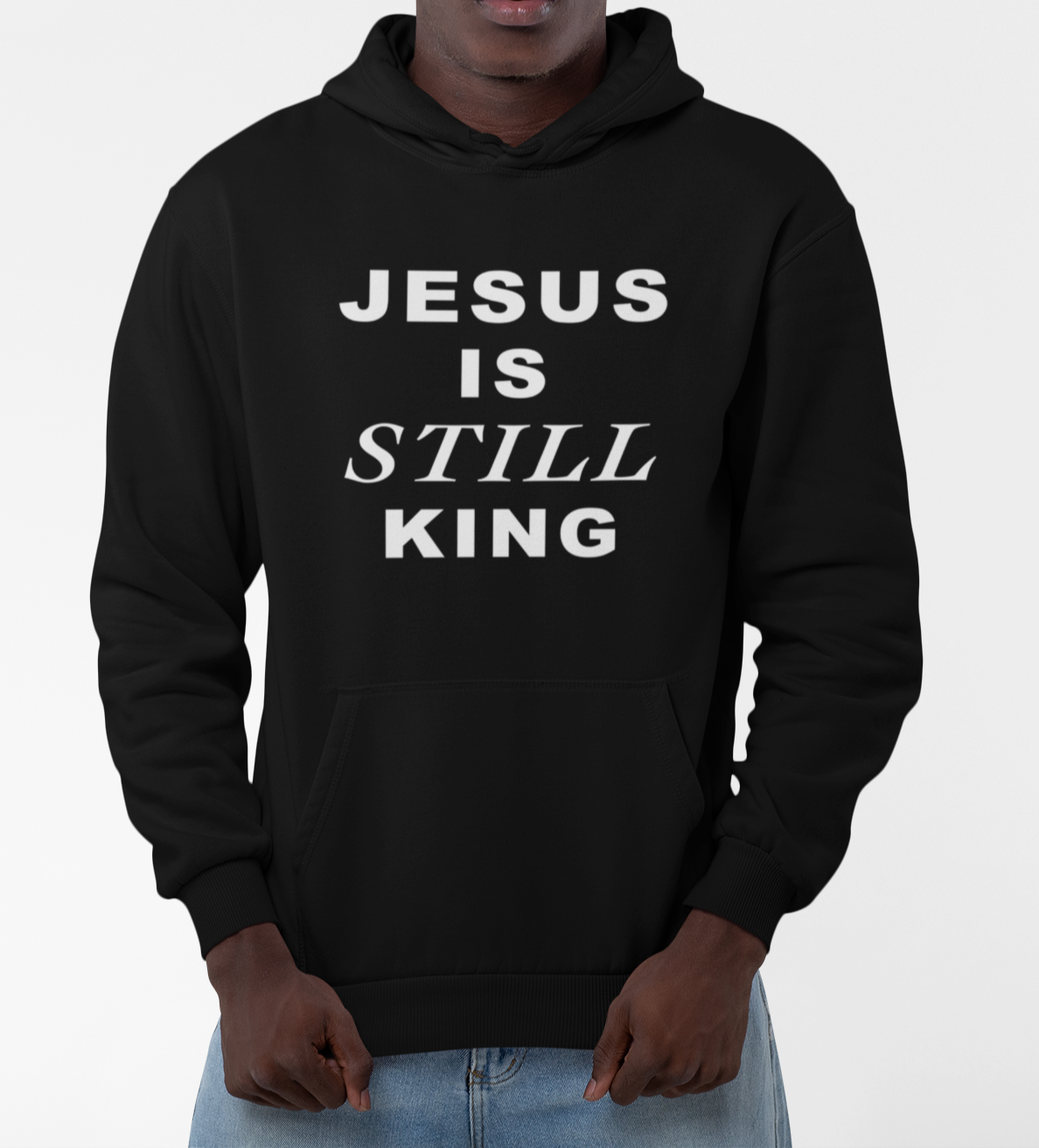Person wearing a black hoodie with 'JESUS IS STILL KING' text on a white background