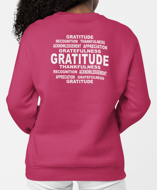 Woman wearing a heliconia sweatshirt with 'Gratitude' text on the back against a white background