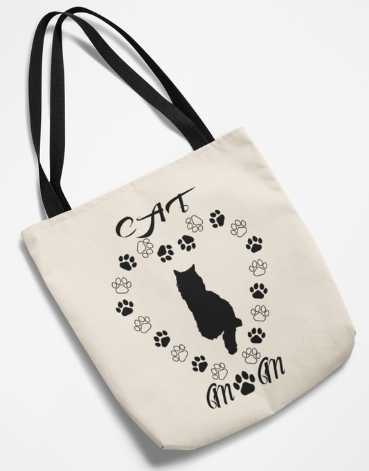 Beige tote bag with black cat silhouette and paw prints on a white background