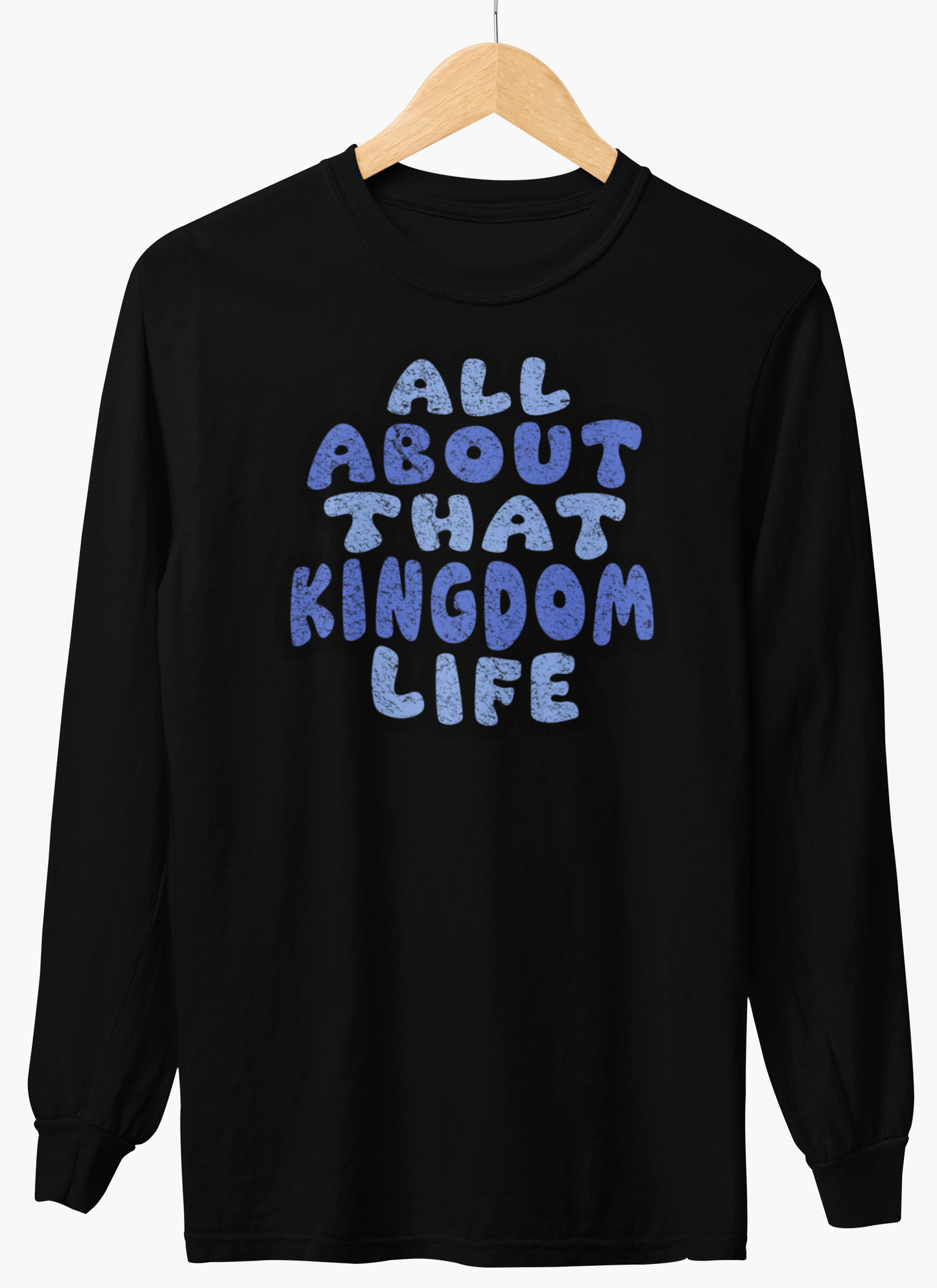 Black long-sleeve shirt with distressed blue text 'All About That Kingdom Life' on a hanger against a white background