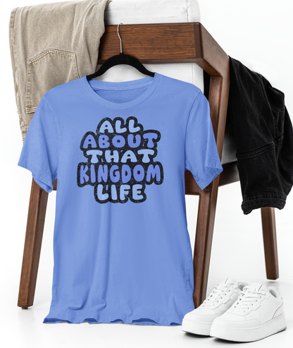 Carolina blue t-shirt with 'All About That Kingdom Life' distressed text on a chair with jeans and sneakers.