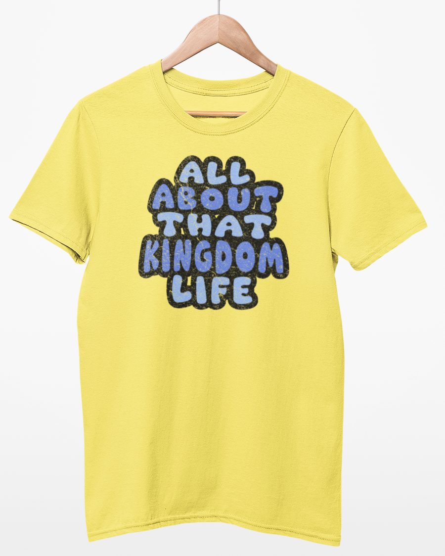 Cornsilk t-shirt with distressed text 'All About That Kingdom Life' on a hanger against a white background