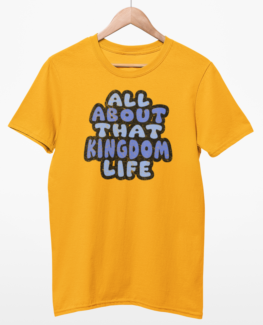 Gold t-shirt with 'All About That Kingdom Life' distressed text on a hanger against a white background