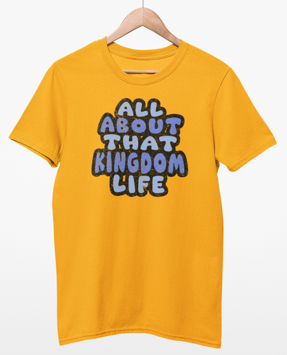 Gold t-shirt with 'All About That Kingdom Life' distressed text on a hanger against a white background