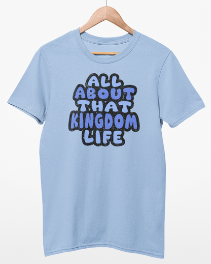 Light blue t-shirt with 'All About That Kingdom Life' distressed text on a hanger against a white background