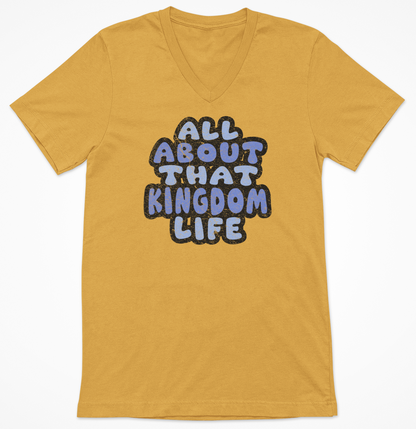 Mustard women's v-neck t-shirt with 'All About That Kingdom Life' distressed text on a white background