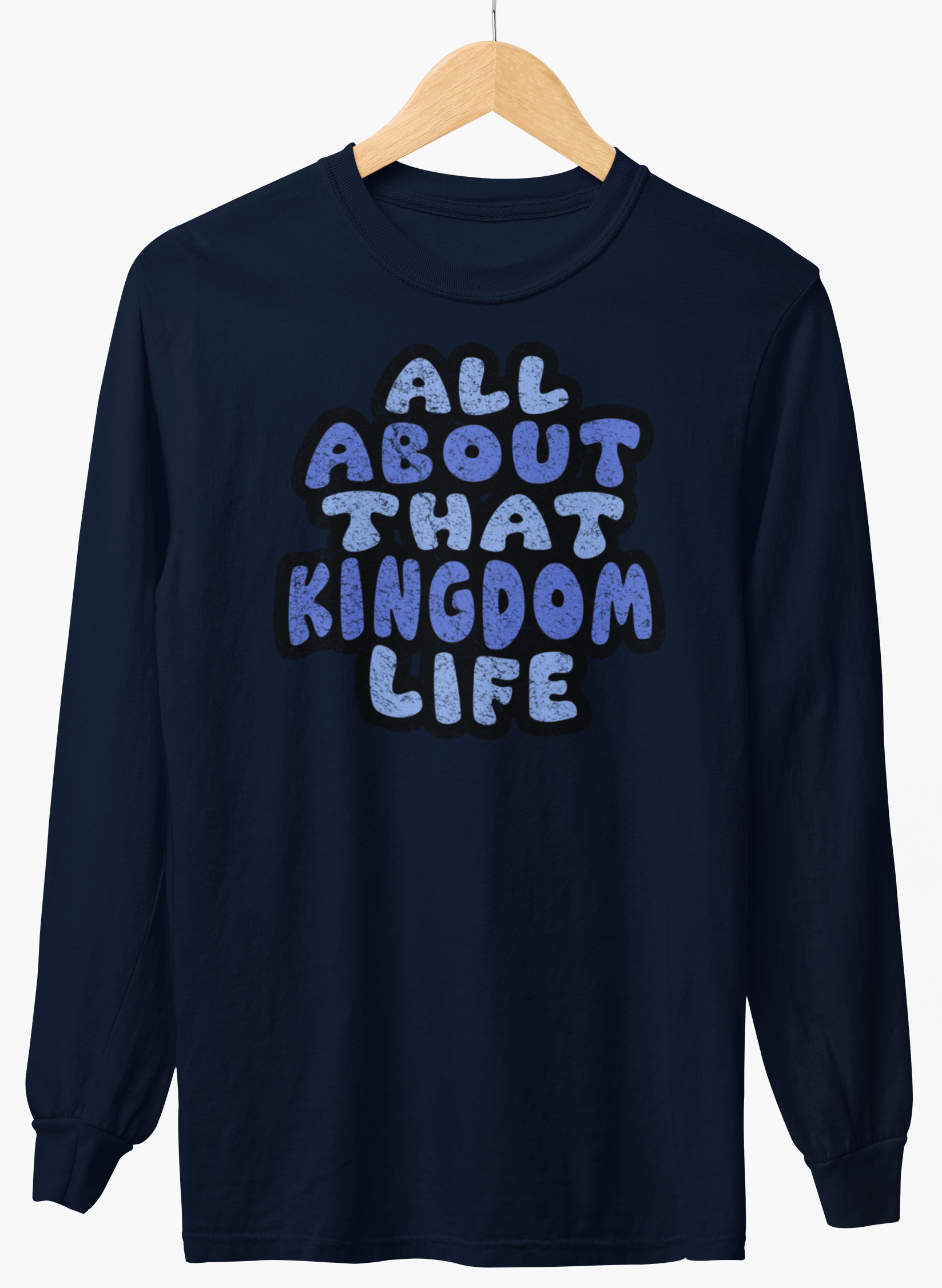 Navy long-sleeve shirt with 'All About That Kingdom Life' distressed text on a hanger against a white background