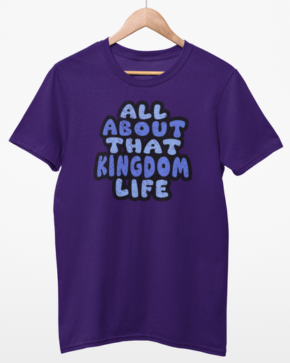 Purple t-shirt with distressed blue text 'ALL ABOUT THAT KINGDOM LIFE' on a hanger against a white background