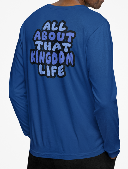 Man wearing a royal blue long-sleeve shirt with distressed text on the back, standing against a plain background