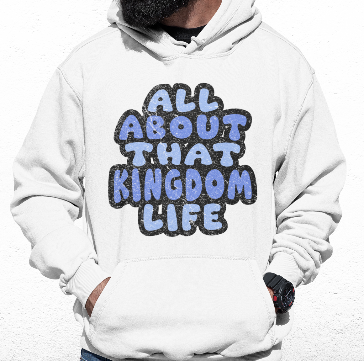 Man wearing a white hoodie with 'All About That Kingdom Life' distressed text on a white background