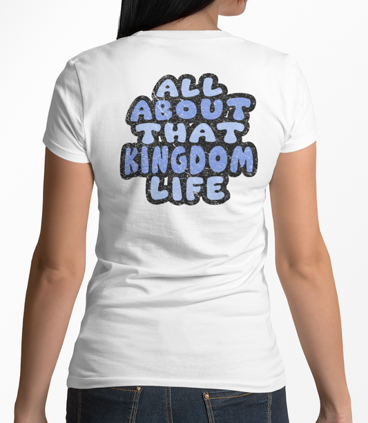 Woman wearing a white women's v-neck t-shirt with 'All About That Kingdom Life' distressed text on the back.