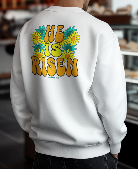 Person wearing a white sweatshirt with 'He Is Risen' text on the back in a store setting