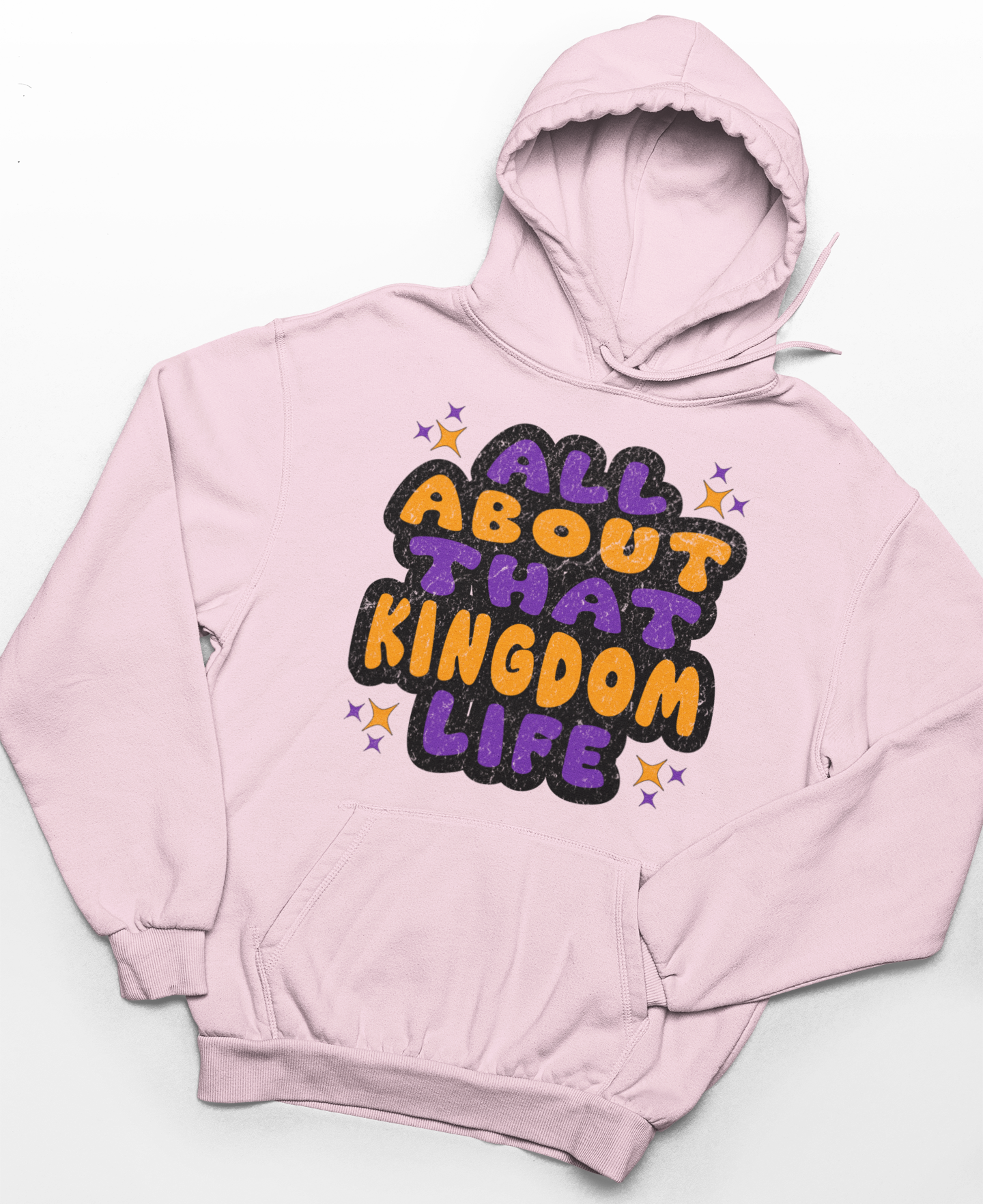Light pink hoodie with distressed orange and purple text 'All About That Kingdom Life' on a white background