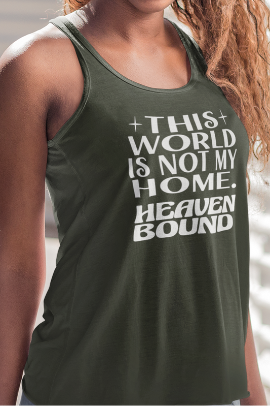 Woman wearing a military green women's racerback tank top with white text, 'THIS WORLD IS NOT MY HOME HEAVEN BOUND'